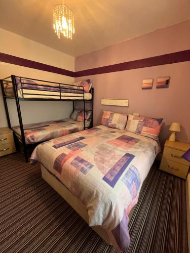 a bedroom with a bed and a bunk bed at Alondra Hotel in Blackpool