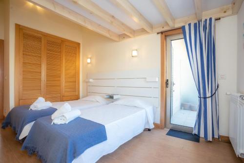 a bedroom with two beds and a large window at Marginal Oceanica Apartment in Buarcos