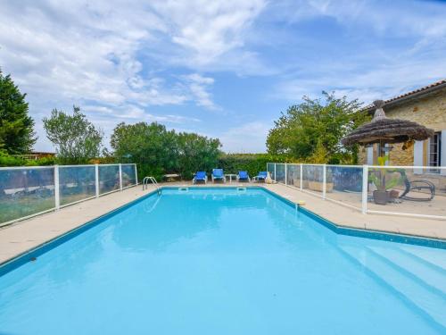 a large swimming pool with a fence around it at Beautiful holiday home with swimming pool in Monprimblanc