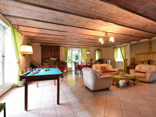 a living room with a table in the middle at Alluring Cottage in Englancourt with Fenced Garden in Englancourt