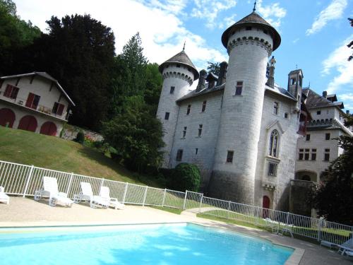 zamek z basenem przed nim w obiekcie Cosy castle with swimming pool w mieście Serrières-en-Chautagne
