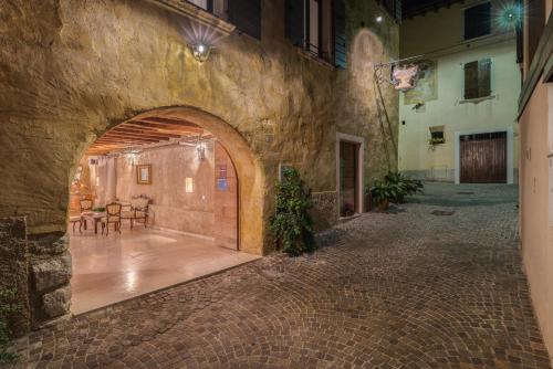 a stone hallway with an archway in a building at Corte Alma Spa and Luxury Home in Gargnano