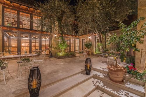 an indoor garden with tables and chairs and plants at Corte Alma Spa and Luxury Home in Gargnano