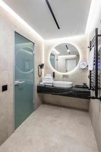 a bathroom with a sink and a mirror at Loft7 in Lviv
