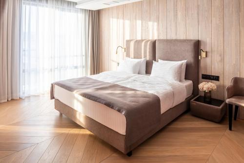 a bedroom with a large bed and a large window at Loft7 in Lviv