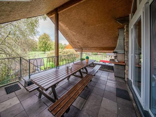 a porch with two wooden benches on a balcony at Charming cottage with jacuzzi and sauna High Fens in Waimes