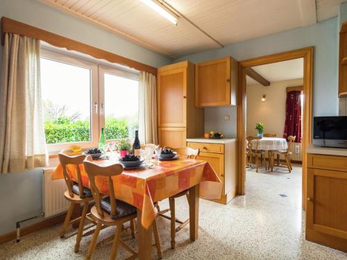 a kitchen and dining room with a table and chairs at Quaint Cottage in Chiny with Private Garden in Chiny