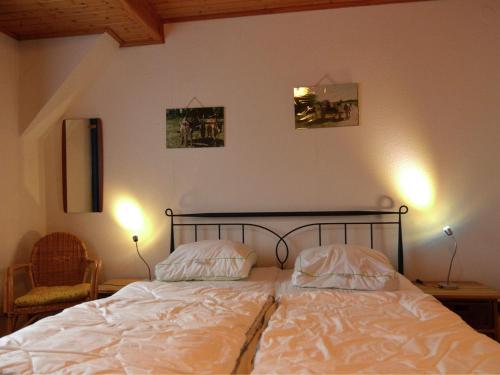 a bedroom with a bed with two pillows on it at Holiday home near the ski lift in Winterberg