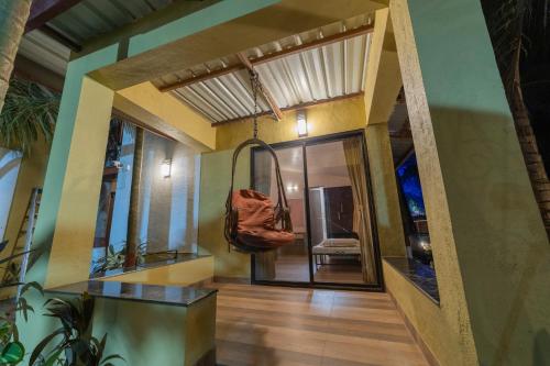 a hallway of a house with a purse hanging from the ceiling at Coconut Beach Farm in Alibaug