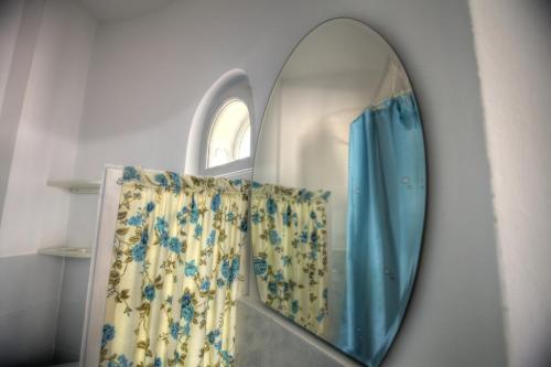 a mirror hanging on a wall with a window at Vila Brancoveanu in Eforie Sud