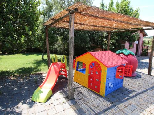 a playground with a slide and a play house at Farmhouse near Montalto di Castro beaches in Montalto di Castro