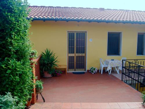 a patio of a house with a table and chairs at Belvilla by OYO Massarella Due in Fucecchio