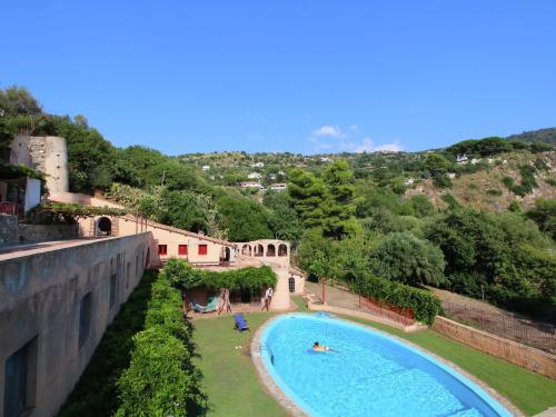 a view of a swimming pool next to a building at Belvilla by OYO Torre in Ricadi