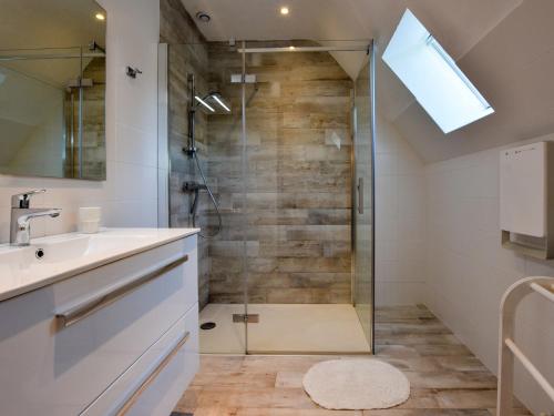 a bathroom with a shower with a glass door at Stylish Holiday Home in Morlaix with Private Garden in Saint-Martin-des-Champs