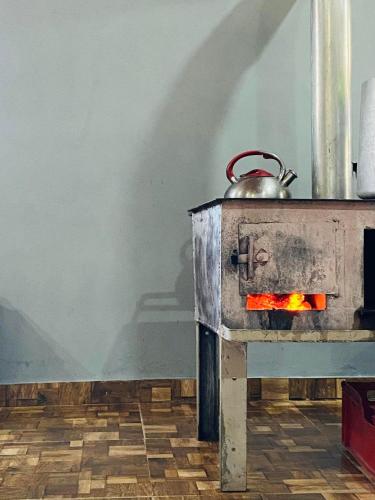 a stove with a pot on top of it at Mamuka's Guesthouse in Udabno