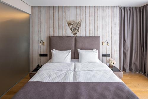 a bedroom with a large bed with white pillows at Loft7 in Lviv