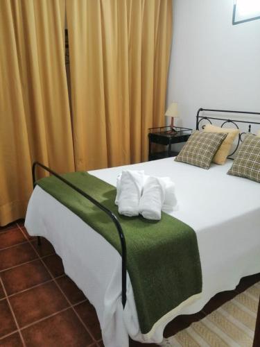 a bedroom with a bed with two pillows on it at Casas da Saibreira - nº10 in Elvas