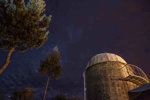 a silo under a starry sky with a tree at Tradicion Colca in Yanque