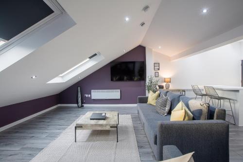 a living room with a couch and a table at Charles Alexander Short Stay - The Gateway in Blackpool