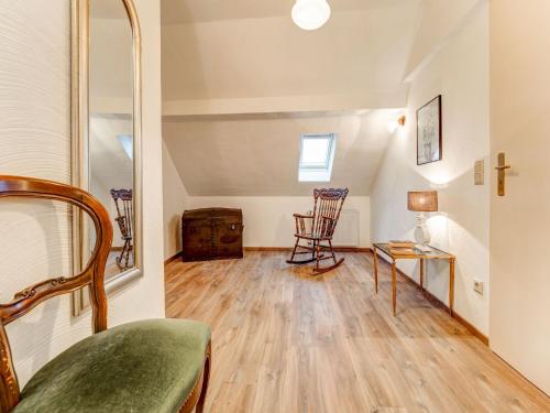 a room with a bed and a table and chairs at Apartment with wellness oasis in Hellenthal