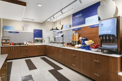 a kitchen with wooden cabinets and a counter top at Holiday Inn Express & Suites Oakhurst-Yosemite Park Area by IHG in Oakhurst