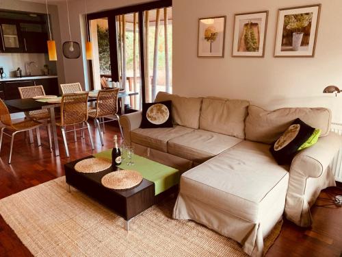 a living room with a couch and a table at Apartament Bornholm in Jurata