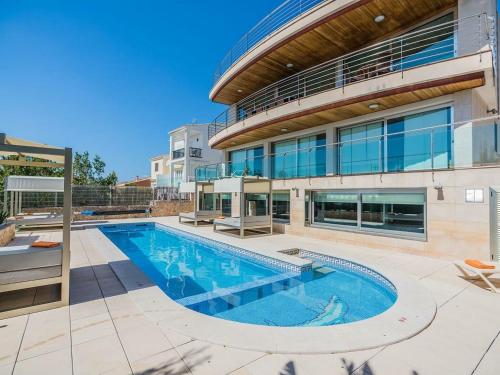 a swimming pool in front of a building at Belvilla by OYO Sammy in Port d'Alcudia