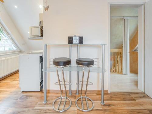a bar with two stools in a kitchen at Apartment in Sch now in Berlin Brandenburg in Bernau bei Berlin