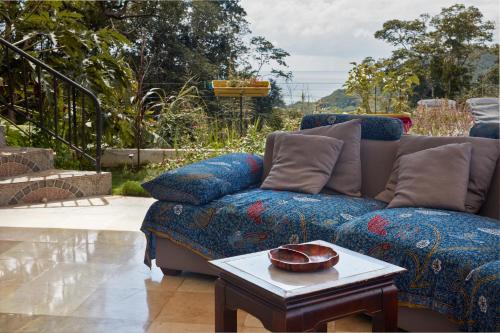 a living room with a couch and a table at Savane Paille in Deshaies