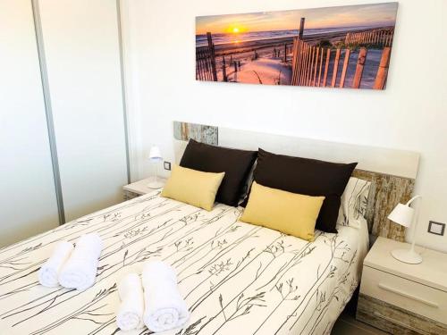 a bedroom with a large bed with yellow pillows at Sol Blanco in Arenales del Sol