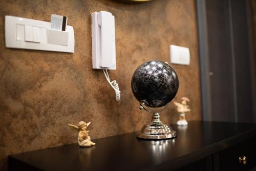 a ball on a table next to a phone at Apartmani Milanovic in Bijeljina