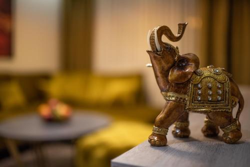 a small figurine of an elephant sitting on a table at Apartmani Milanovic in Bijeljina
