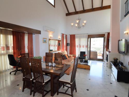 comedor y sala de estar con mesa y sillas en Belvilla by OYO Villa Orange, en Algorfa