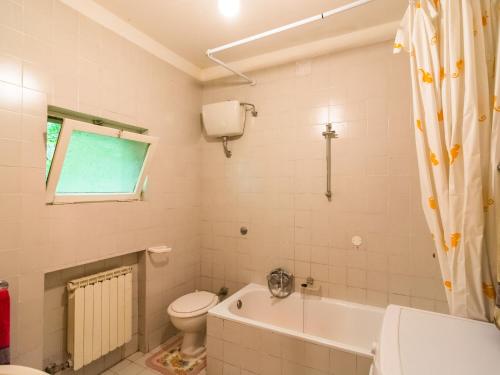 a bathroom with a tub and a toilet and a sink at Beautiful vacation home in San Marcello Pistoiese