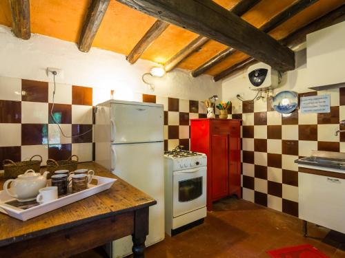 a kitchen with a refrigerator and a counter with a stove at Beautiful vacation home in San Marcello Pistoiese
