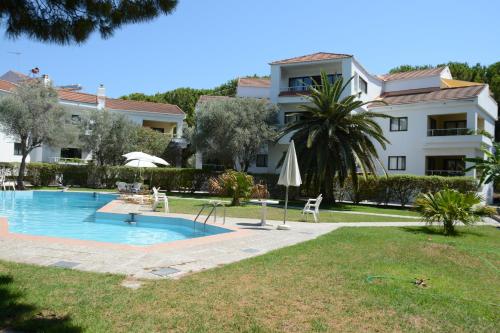 a resort with a swimming pool and a building at Niki Hotel Apartments in Ialyssos