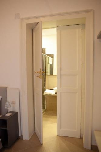 an open door leading to a bathroom with a sink at CasaPaola b&b Rooms in Acireale