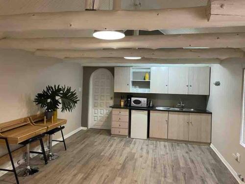 a kitchen with a table and a counter top at Grace Gardens - Grace in Pretoria