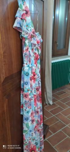 a dress is hanging on a wall at Il Borgo Del Lupo Relax Family Apartments in Tuscany with Restaurant & Swimming Pool in Sarteano