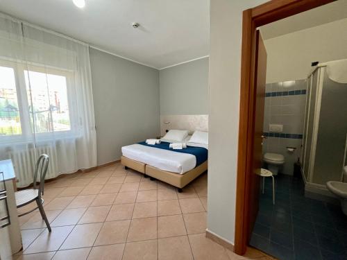 a small bedroom with a bed and a bathroom at Al Centro in Verbania