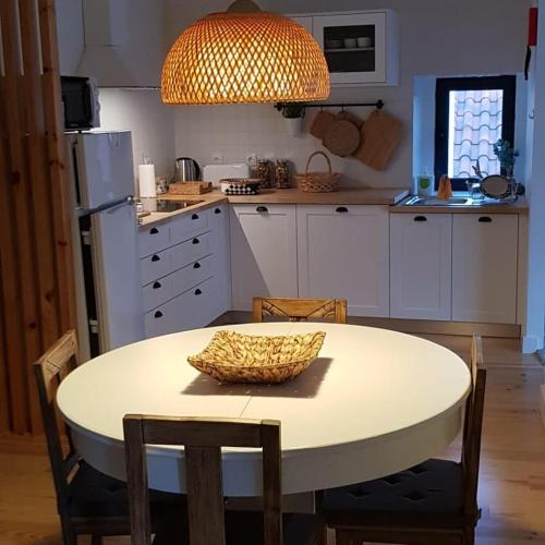 a kitchen with a table with a bowl on it at CASA ANDORINHAS in Fontainhas