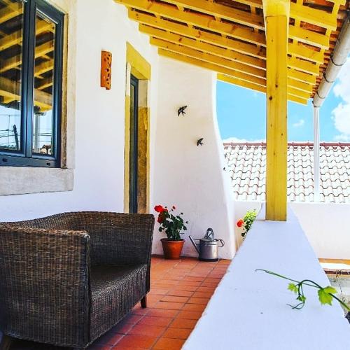 a patio with a table and chairs on a house at CASA ANDORINHAS in Fontainhas