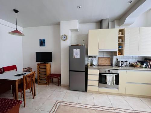 a kitchen with a refrigerator and a table at La Gare Apartment in Varna City