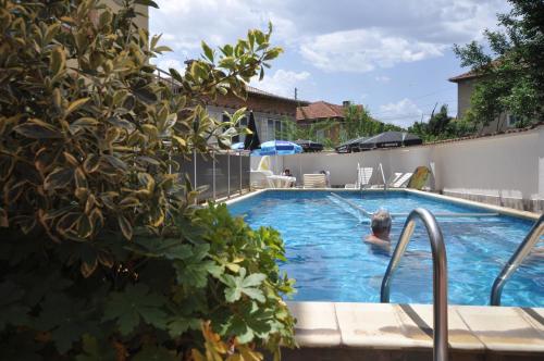 a person swimming in a swimming pool at Family Hotel Dalia in Velingrad