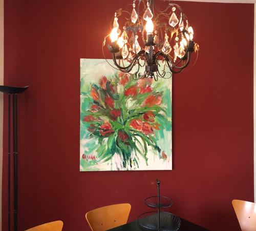 a painting of a flower on a wall with a chandelier at Gästehaus Susanne Pfaffmann in Landau in der Pfalz