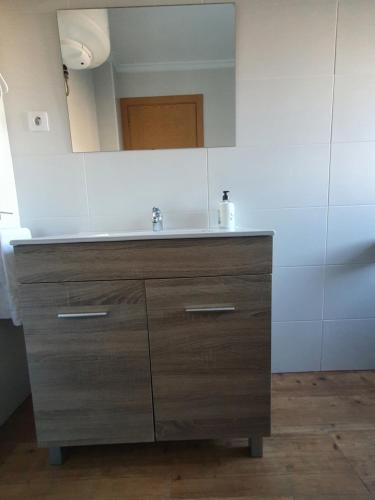 a bathroom with a sink and a mirror at CASTRO - LA COLINA in Arnuero