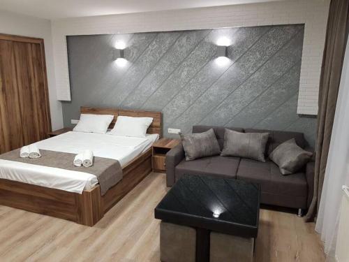 a hotel room with a bed and a couch at Tbilisi House in Tbilisi City