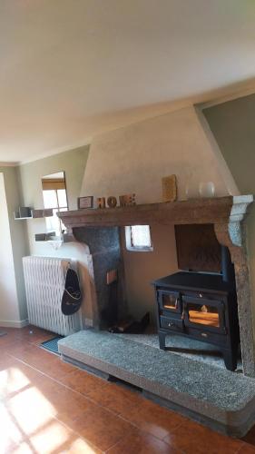 a living room with a stone stove in a room at STONE in Crodo