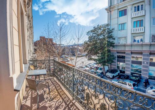 a balcony with a bench and a city street at Vintage Hotel in Tbilisi City