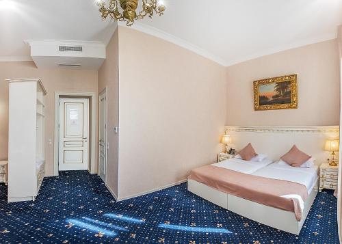 a hotel room with a bed and a corridor at Vintage Hotel in Tbilisi City